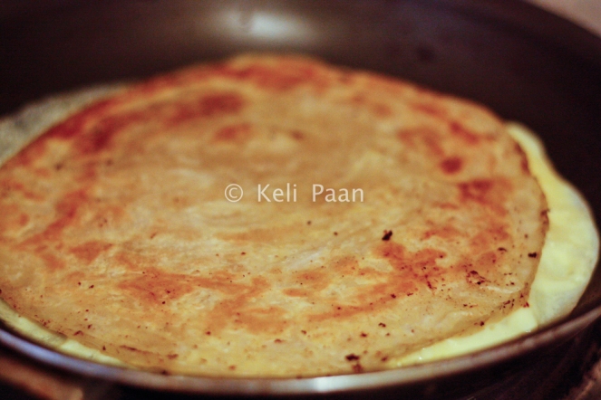 Add the paratha over the egg..